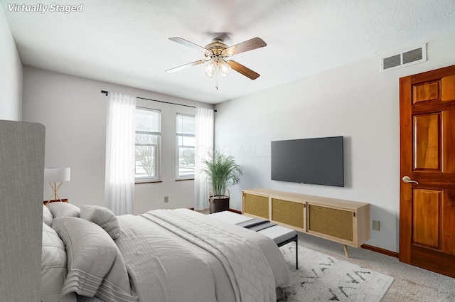 carpeted bedroom with ceiling fan