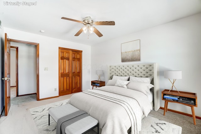 carpeted bedroom with a closet and ceiling fan