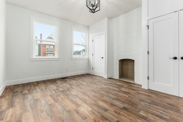 interior space featuring a large fireplace and hardwood / wood-style floors