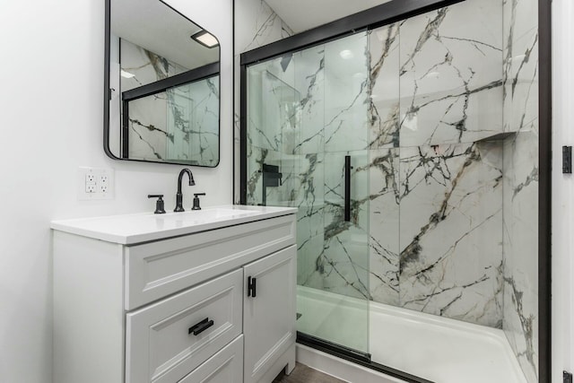 bathroom featuring vanity and an enclosed shower