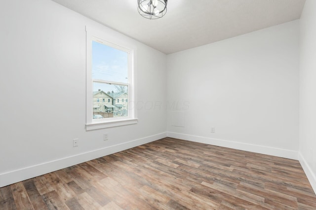 spare room featuring wood-type flooring