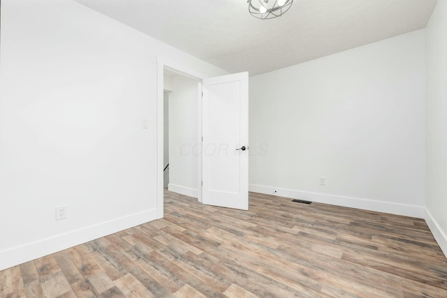 spare room with hardwood / wood-style flooring