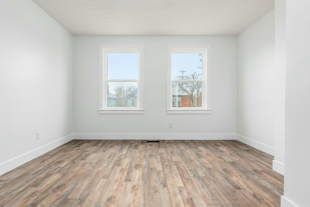 unfurnished room with hardwood / wood-style floors