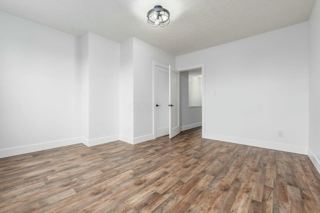 empty room with dark hardwood / wood-style floors