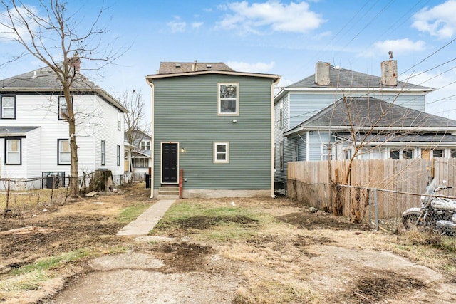 rear view of house featuring central AC unit