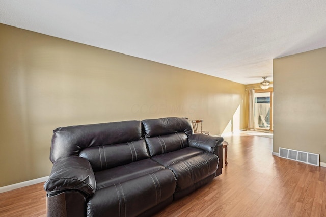 living room featuring light wood-type flooring and ceiling fan