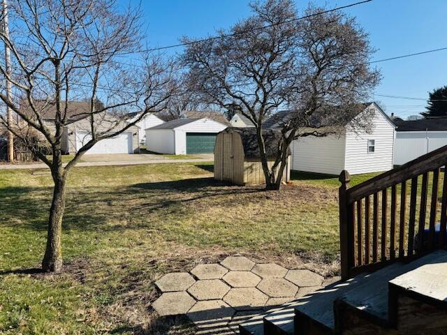 view of yard featuring a shed and a garage