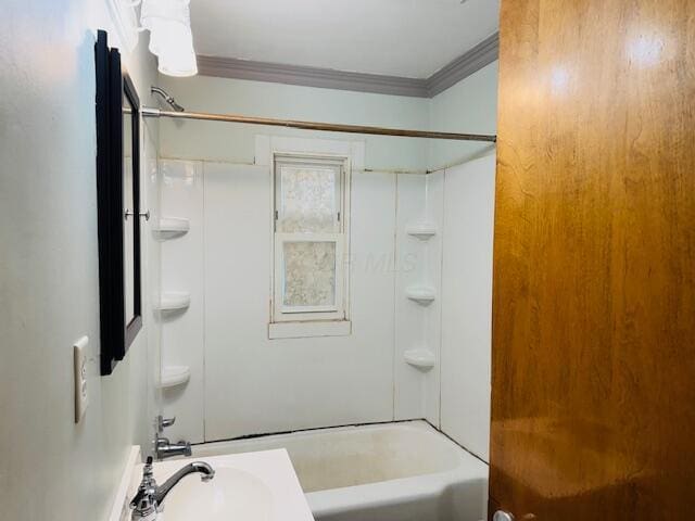 bathroom with crown molding, sink, and bathing tub / shower combination