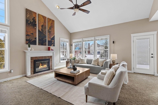 living room with light carpet, high vaulted ceiling, a brick fireplace, and baseboards