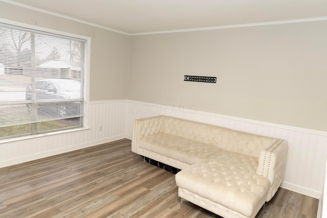 sitting room with ornamental molding and hardwood / wood-style floors