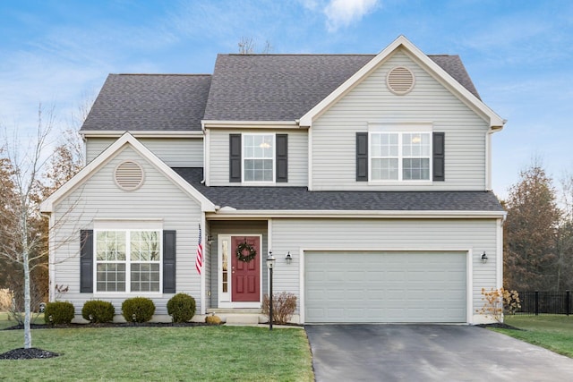 view of front of house with a garage and a front yard