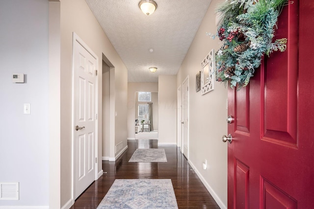 interior space featuring dark hardwood / wood-style flooring and a textured ceiling