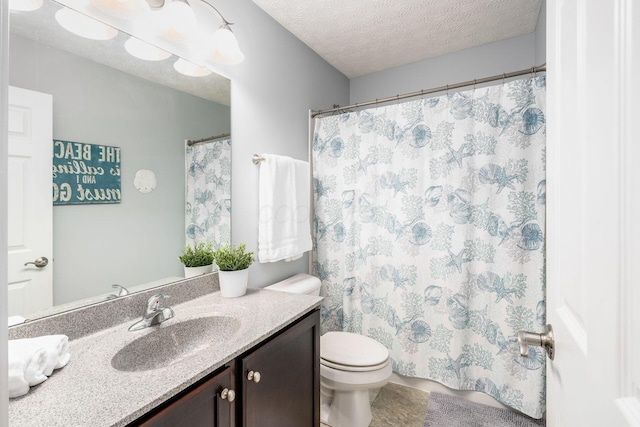 bathroom featuring vanity, toilet, and a textured ceiling