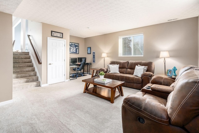 living room with light carpet and a textured ceiling