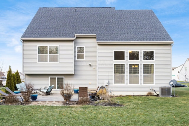 back of house featuring a patio, a yard, and central AC