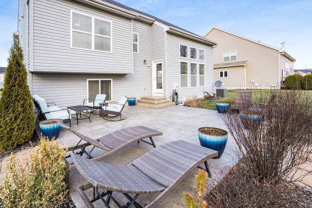 rear view of property featuring cooling unit and a patio