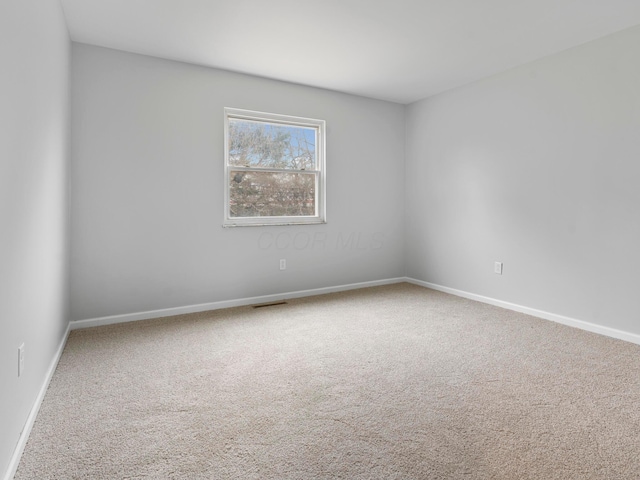 unfurnished room featuring carpet