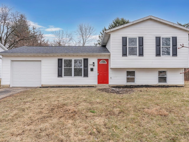 split level home with a garage and a front yard