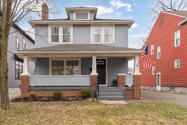 view of front facade with a front yard and covered porch