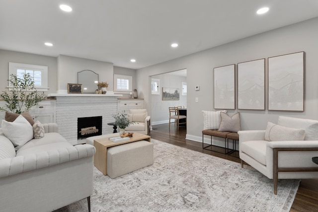 living room with hardwood / wood-style flooring and a fireplace