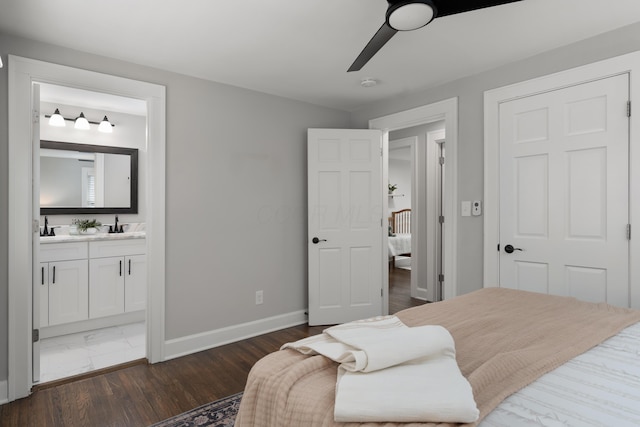 bedroom featuring ensuite bath, wet bar, dark hardwood / wood-style floors, and ceiling fan