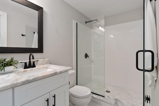 bathroom with vanity, toilet, and walk in shower