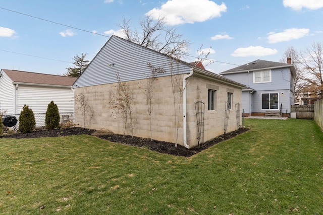 view of side of home featuring a yard