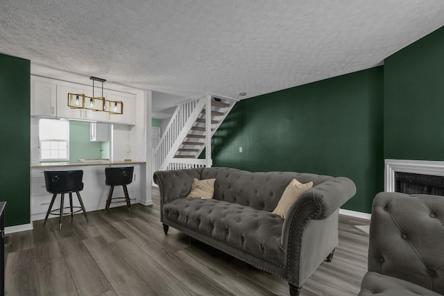 living room featuring hardwood / wood-style floors and a textured ceiling