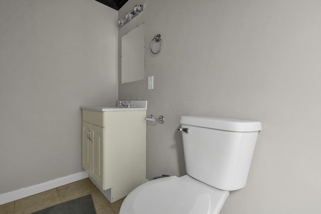 bathroom featuring vanity, tile patterned flooring, and toilet