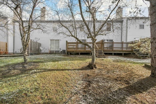 back of house featuring cooling unit, a yard, and a deck