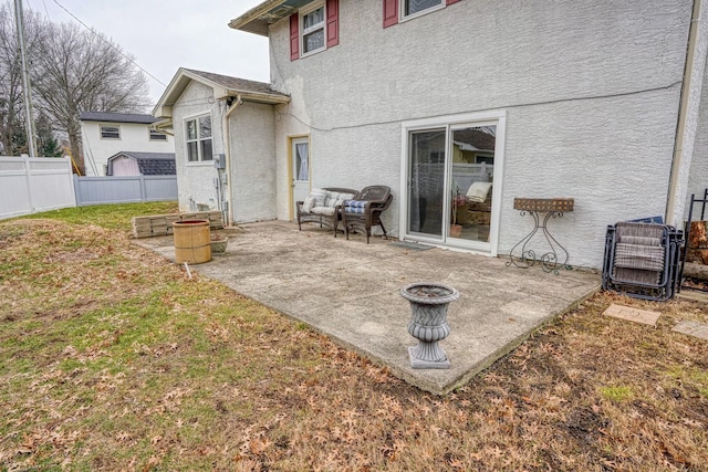 back of house featuring a patio area and a lawn