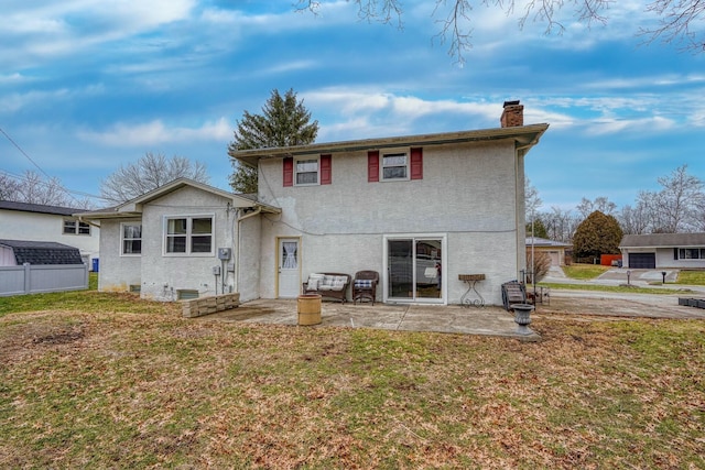 back of house featuring a patio area and a lawn