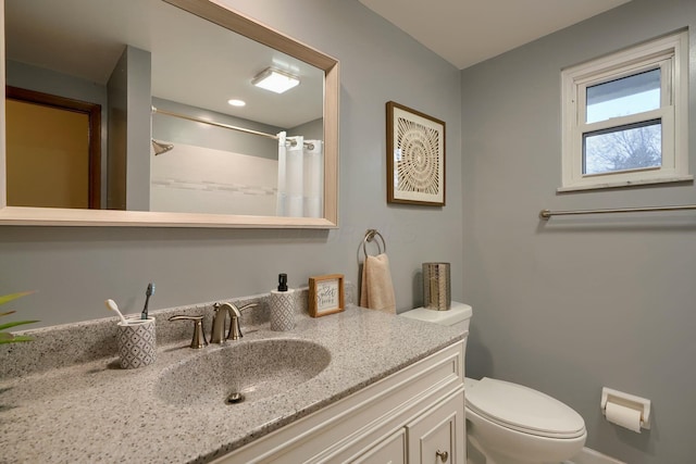 bathroom with vanity, toilet, and a shower with shower curtain