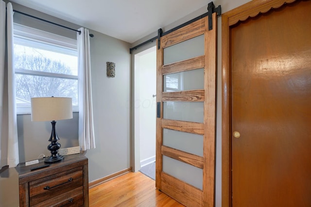 interior space featuring a barn door and light wood-type flooring