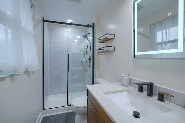 bathroom featuring walk in shower, vanity, and toilet