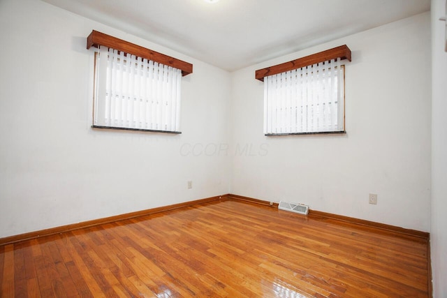 empty room with hardwood / wood-style floors