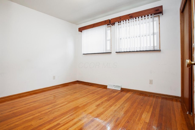 unfurnished room with wood-type flooring