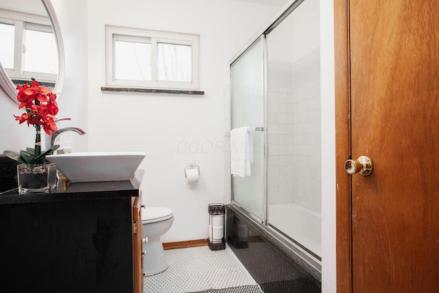 full bathroom featuring tile patterned flooring, enclosed tub / shower combo, vanity, and toilet