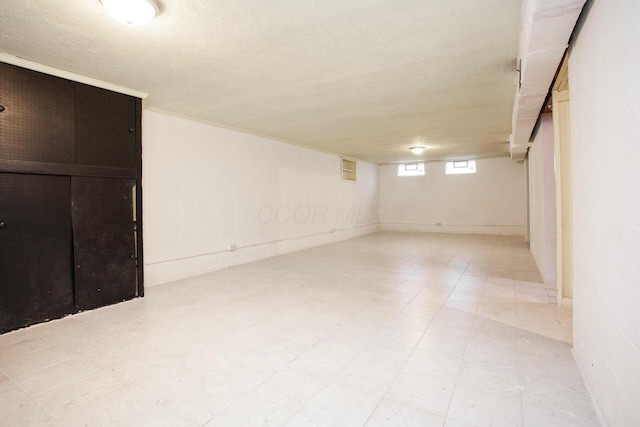 basement featuring a textured ceiling