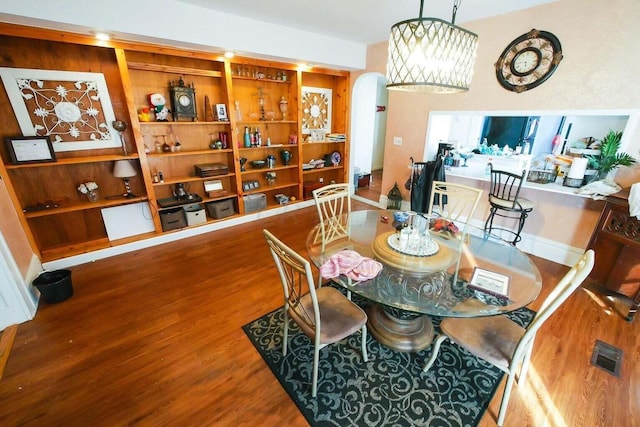 dining space with hardwood / wood-style flooring