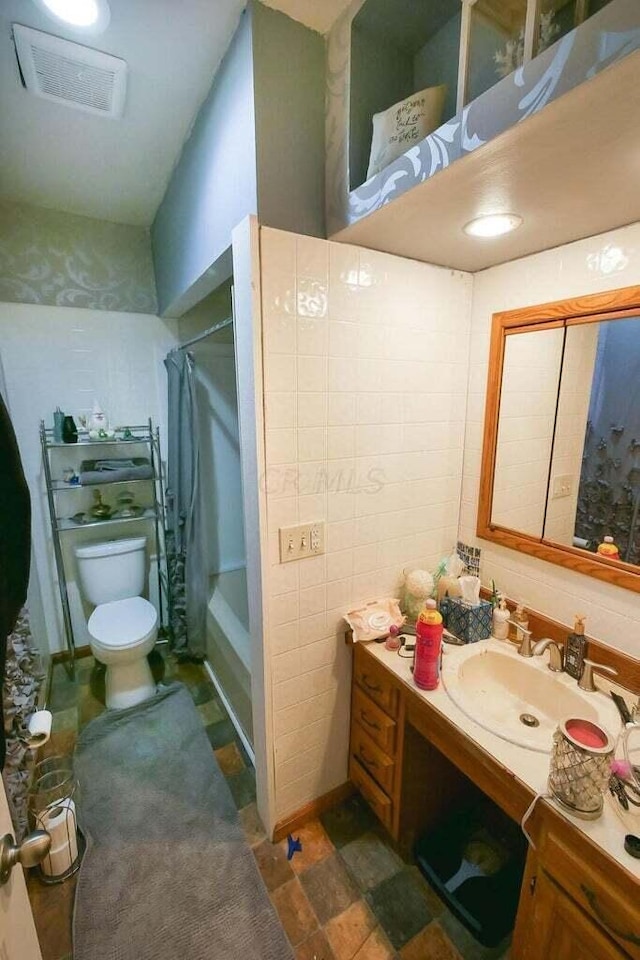 full bathroom featuring vanity, toilet, and shower / bath combo with shower curtain