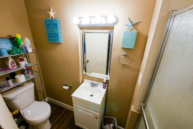 bathroom with vanity, hardwood / wood-style floors, and toilet