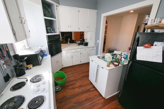 kitchen featuring white cabinets, dark hardwood / wood-style flooring, and black appliances