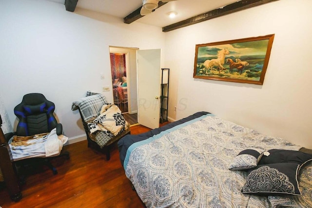 bedroom with beamed ceiling and dark wood-type flooring