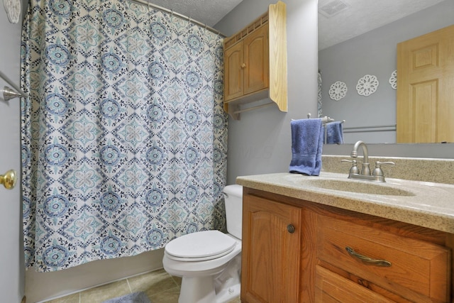 full bathroom with visible vents, toilet, tile patterned flooring, a textured ceiling, and vanity