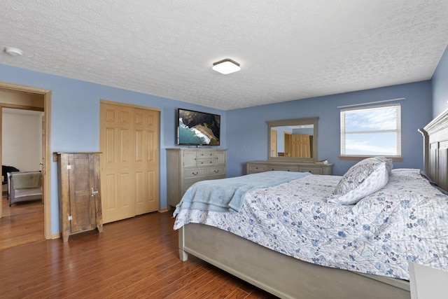 bedroom featuring dark wood-style floors and a textured ceiling