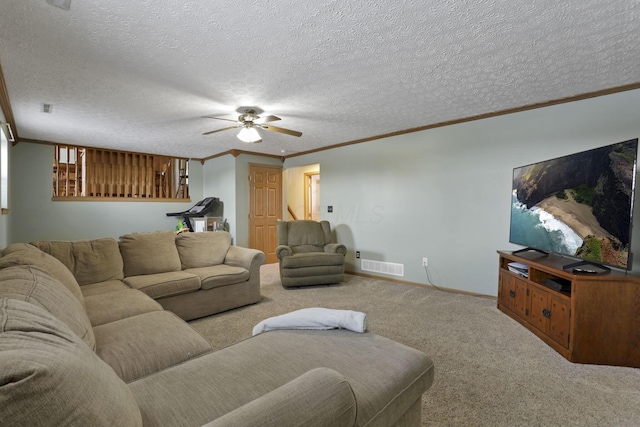 carpeted living area with baseboards, visible vents, ceiling fan, a textured ceiling, and crown molding