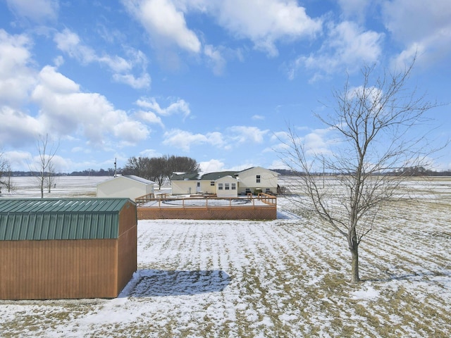 yard covered in snow featuring an outdoor structure