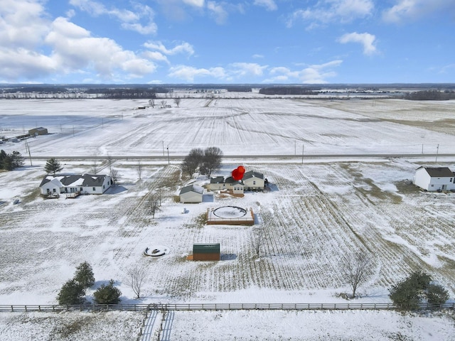 snowy aerial view featuring a rural view