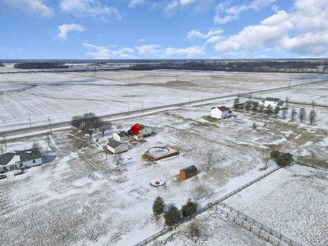 snowy aerial view featuring a rural view